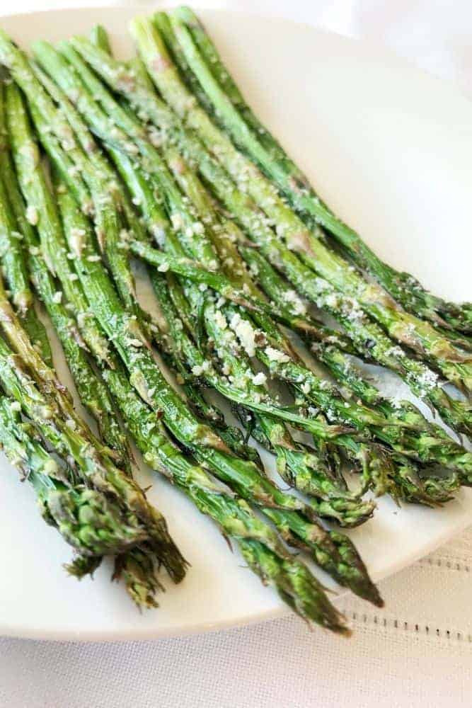 Air fryer Asparagus with parmesan on a white plate