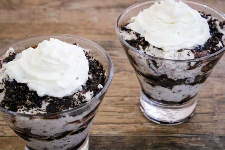 Two Oreo Cheesecake Mousse Bowls with whipped cream on top