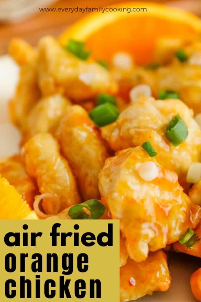 Title and Shown: Air Fried Orange Chicken (with green onions on a white plate)