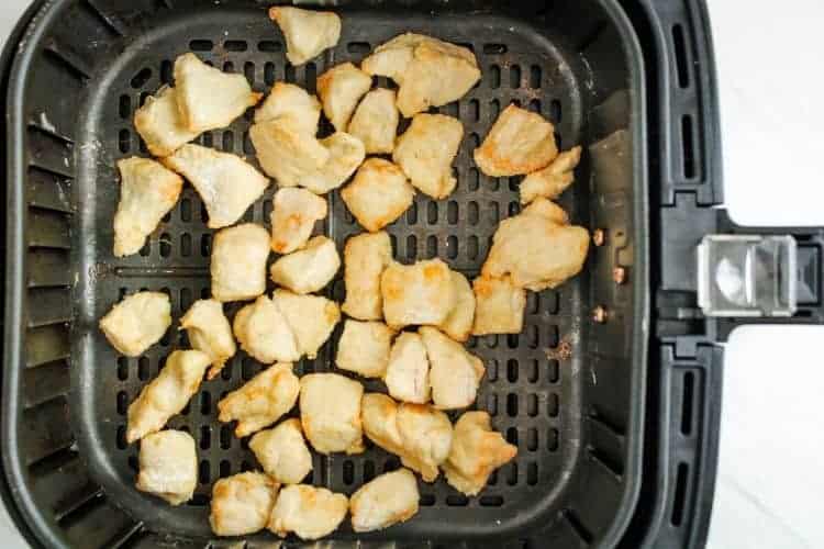 Cooked cubed chicken inside air fryer