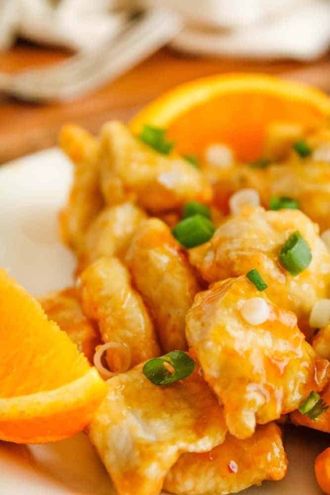 Orange chicken plated with oranges