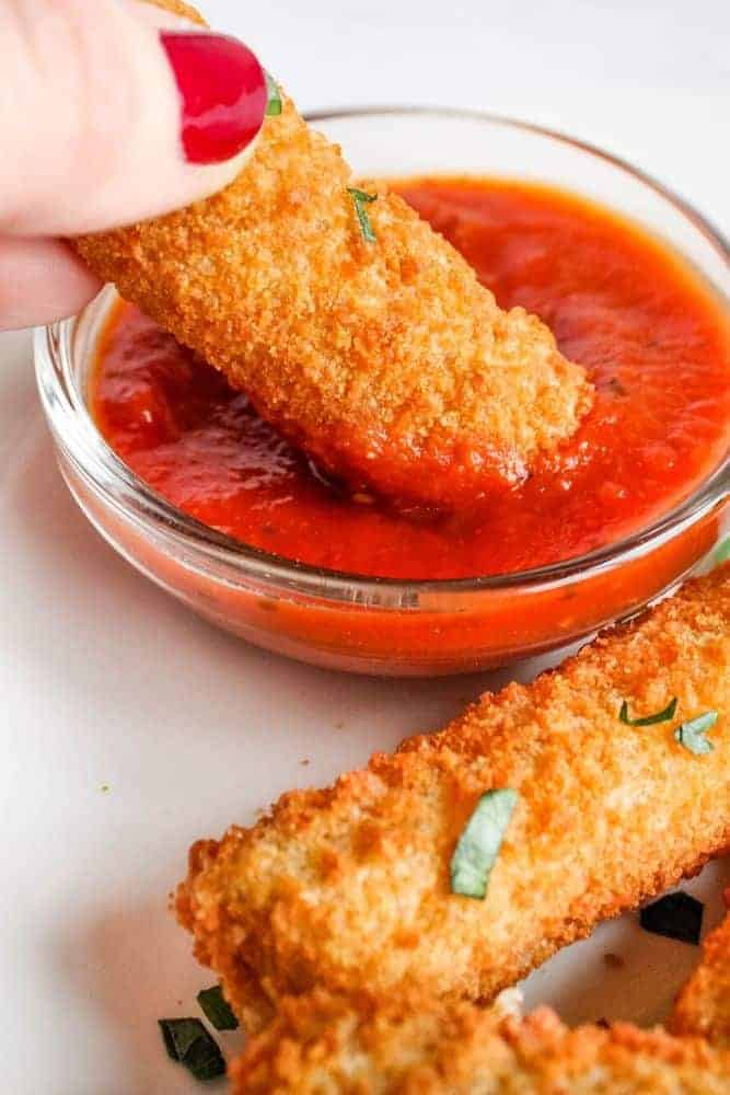 Dipping Mozzarella Stick in Marinara Sauce