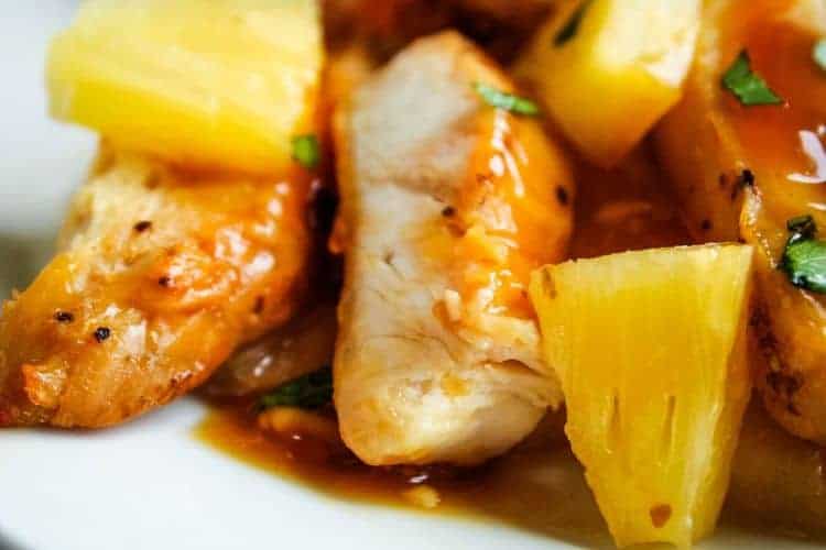 Super closeup of Pineapple Chicken on a white plate