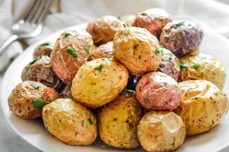 Roasted Baby Potatoes on a white plate with fork to the side