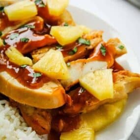Pineapple Chicken with Pineapple Chunks on a white plate