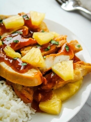 Pineapple Chicken with Pineapple Chunks on a white plate