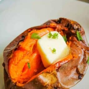 Air Fryer Baked Sweet Potato cut in half with butter in the middle