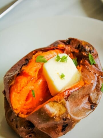 Air Fryer Baked Sweet Potato cut in half with butter in the middle