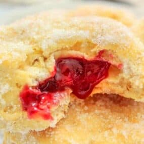 Air Fryer Jelly Donuts stacked with jelly oozing out