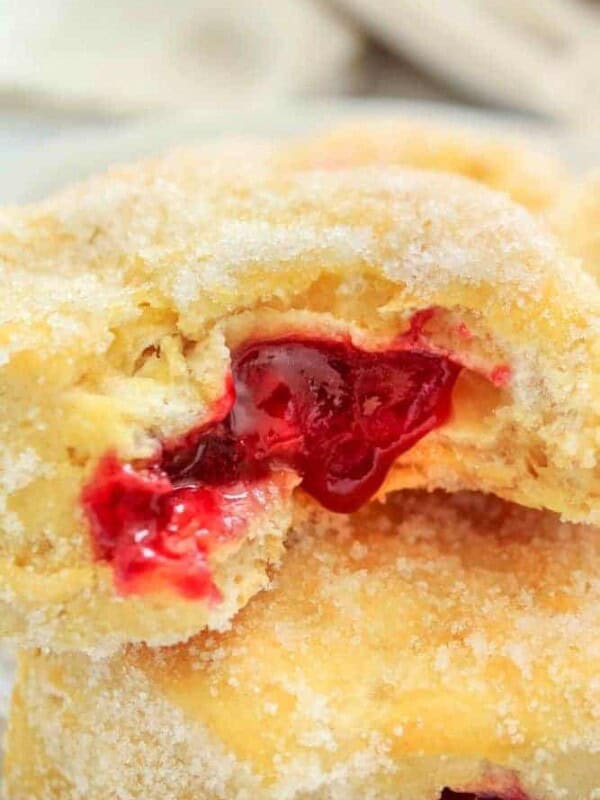 Air Fryer Jelly Donuts stacked with jelly oozing out