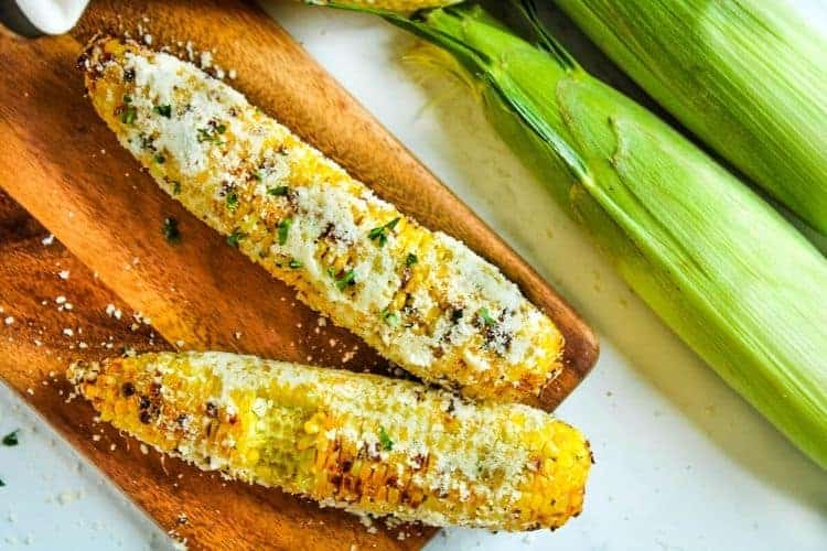 Air Fryer Corn on the Cob with bite taken out of it on a cutting board