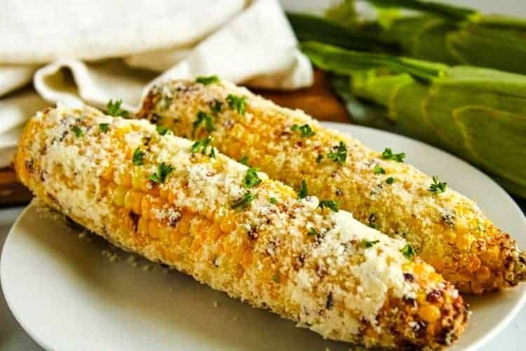 Corn on the Cob cooked in the air fryer on a white plate
