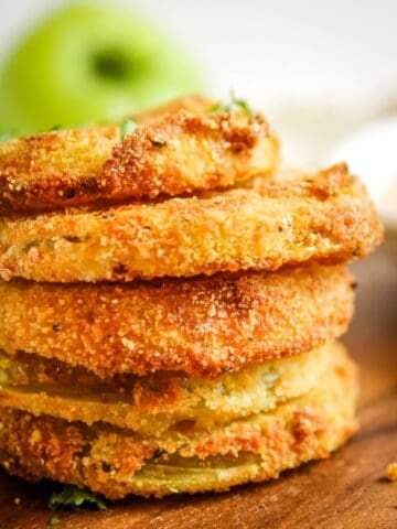 Side view of stacked air fryer green tomatoes to see the golden brown and crispy spots.