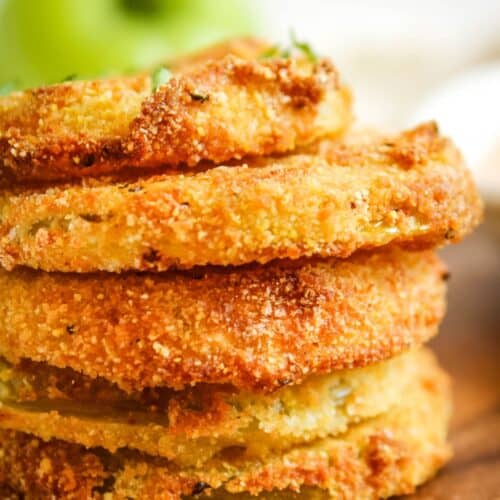 Side view of stacked air fryer green tomatoes to see the golden brown and crispy spots.