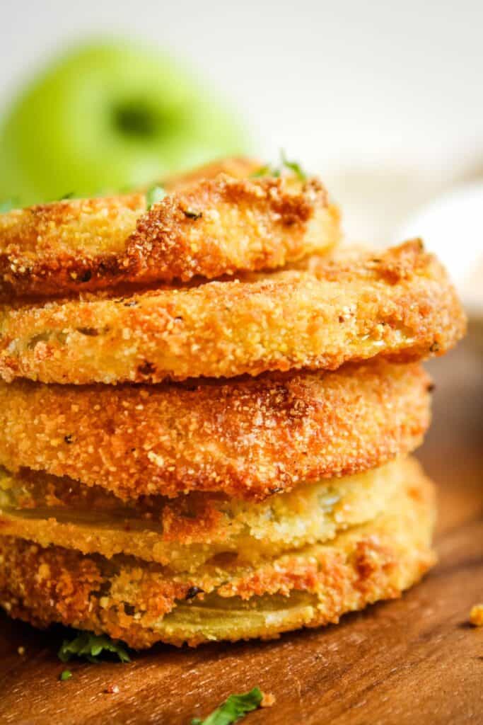 Side view of stacked air fryer green tomatoes to see the golden brown and crispy spots.