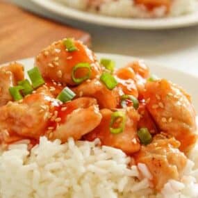 Air Fryer Sweet and Sour Chicken served over rice on a white plate
