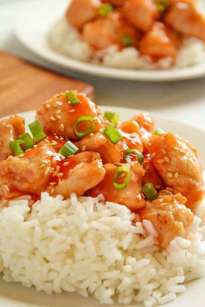 Air Fryer Sweet and Sour Chicken served over rice on a white plate