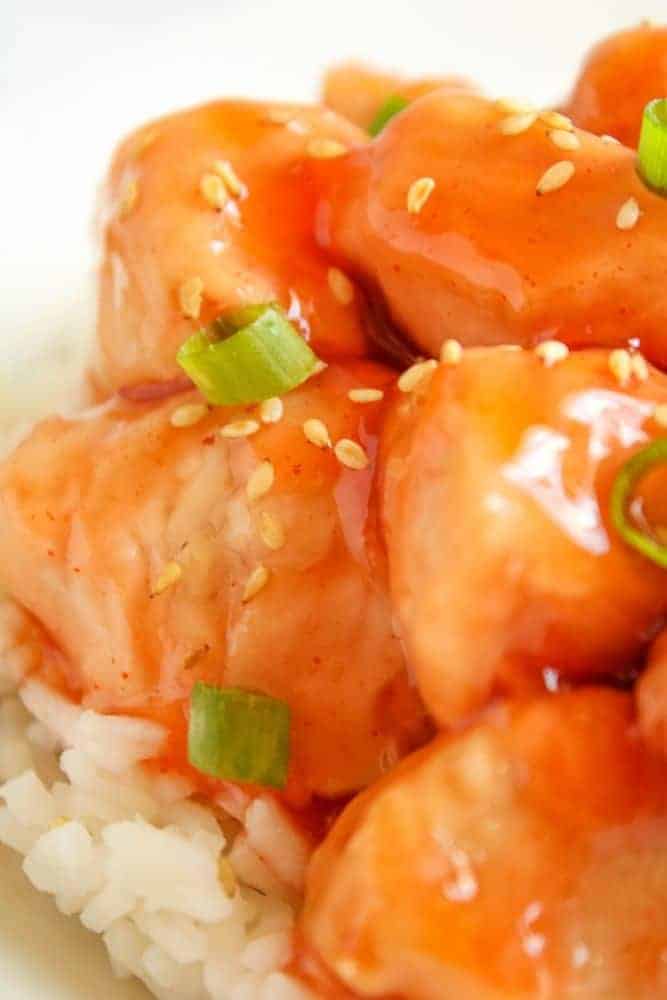 Closeup of Sweet and Sour Chhicken with rice peeking out underneath