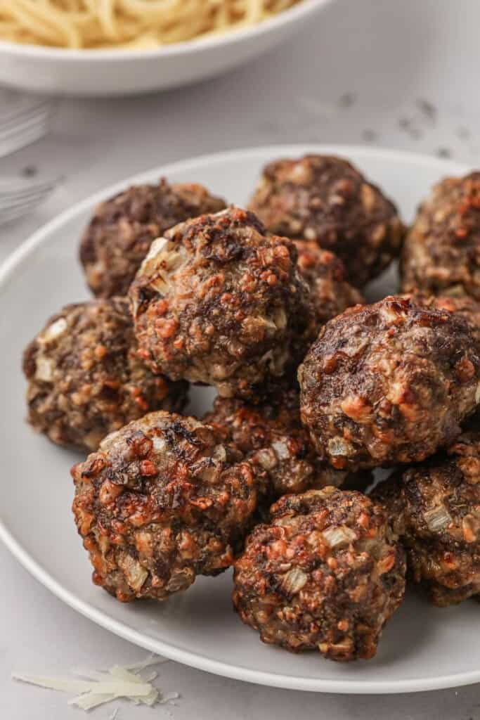 Cooked meatballs stacked on a plate