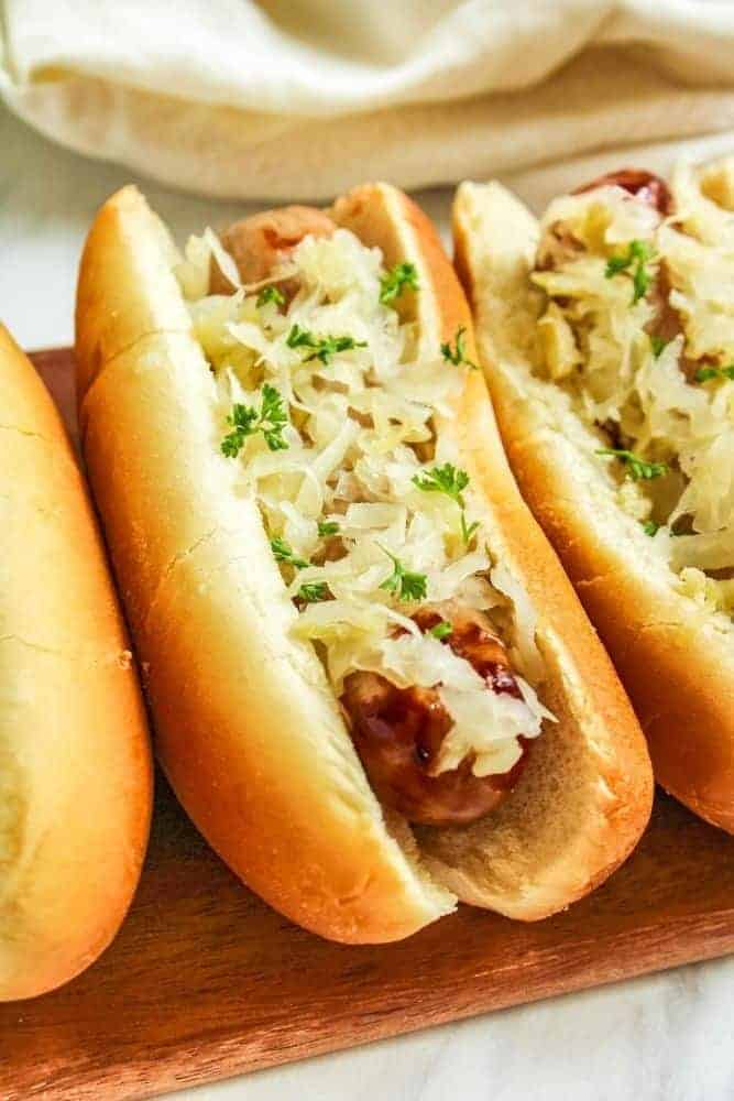 Air Fryer Brats in a bun with sauerkraut on top