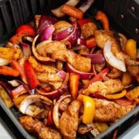 Raw chicken fajitas inside air fryer