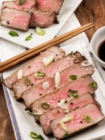 Air Fryer Tuna Steaks sliced on a rectangular plate with chopsticks