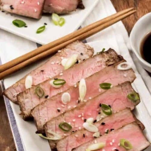 Air Fryer Tuna Steaks sliced on a rectangular plate with chopsticks