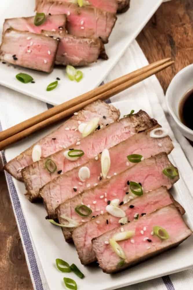 Air Fryer Tuna Steaks sliced on a rectangular plate with chopsticks