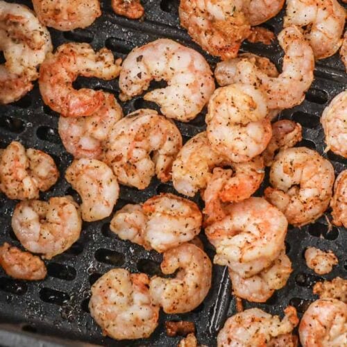 Closeup of shrimp in air fryer basket