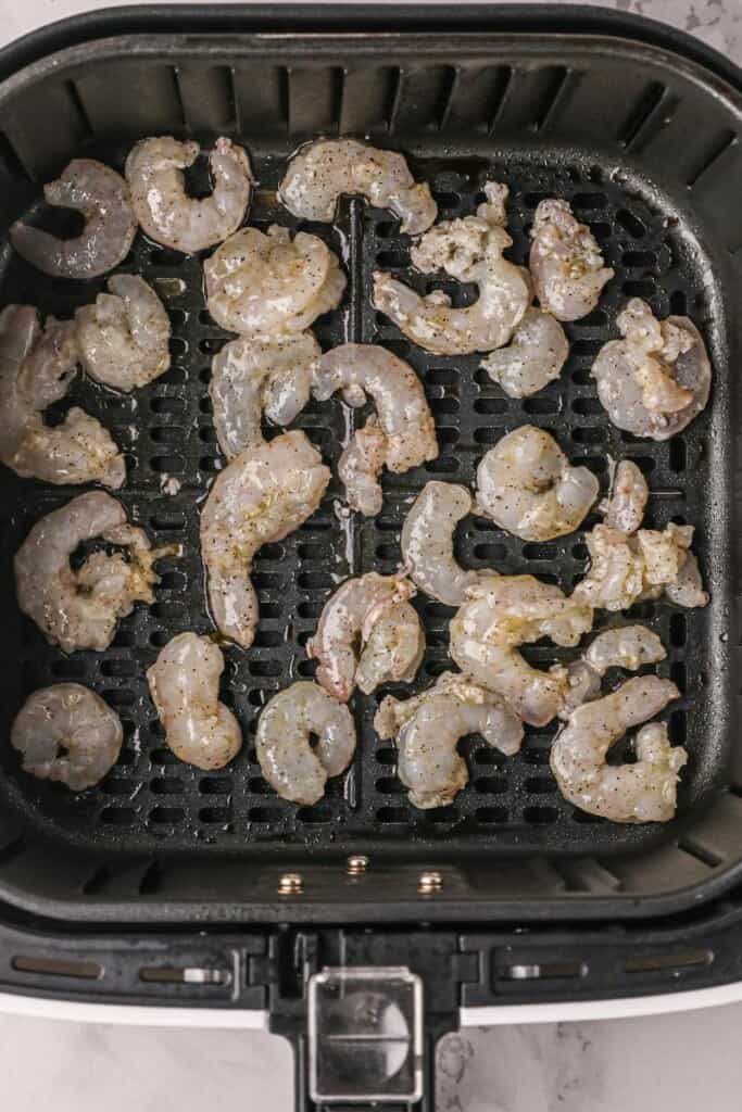 Raw shrimp in air fryer basket