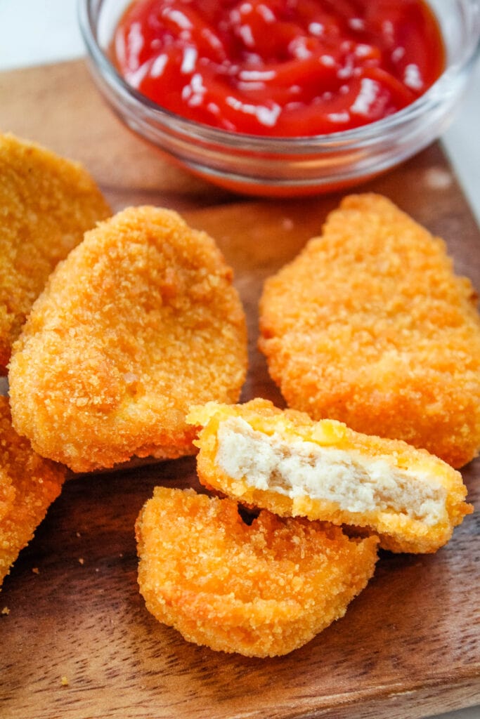 Air Fryer Chicken Nuggets with one bitten into 