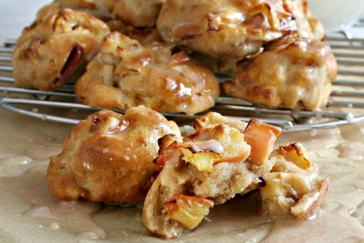 Air Fryer Apple Fritters on wire rack with one cut in half
