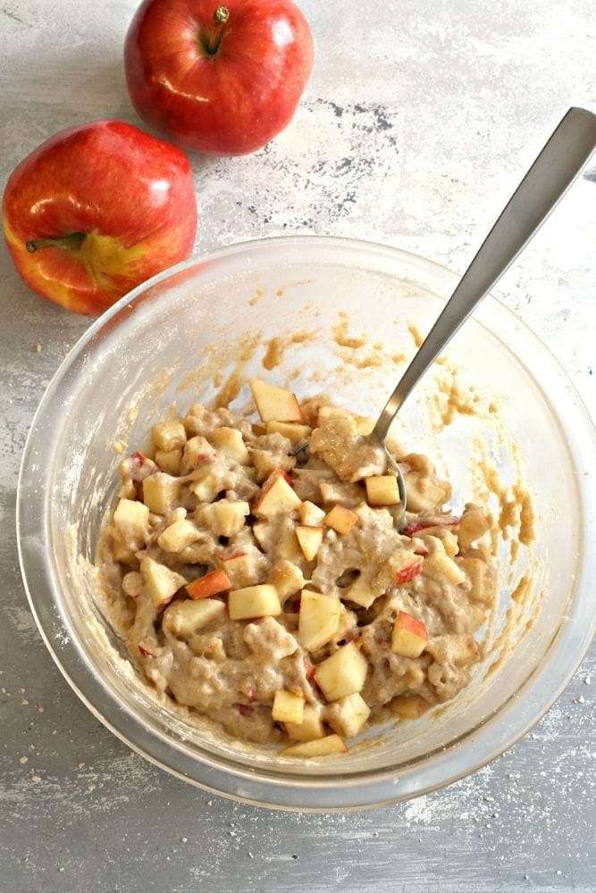 Air Fryer Apple Fritter mixture in a clear bowl with spoon