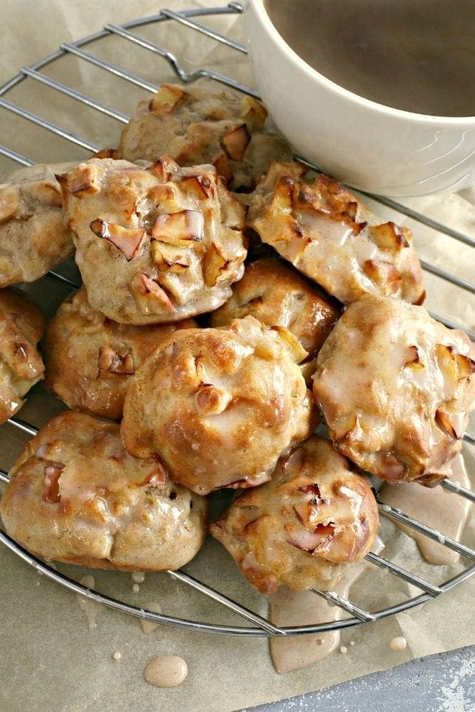 Air Fryer Apple Fritters on a wire rack with coffee in a white mug