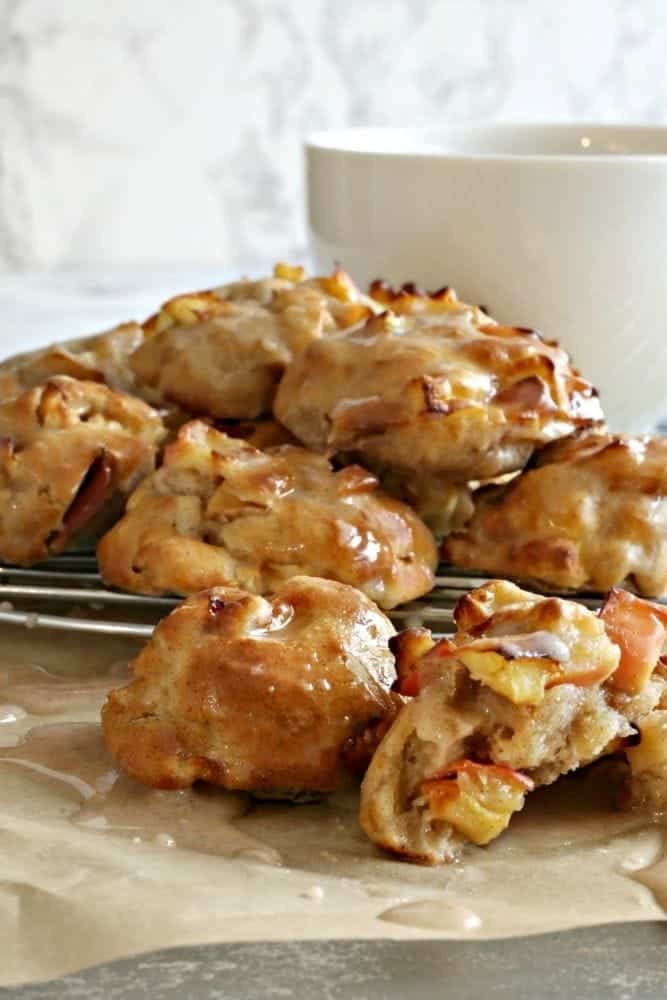 Air Fryer Apple Fritters on a wire rack with a white mug