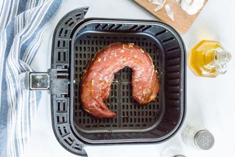 Raw marinated pork tenderloin in air fryer