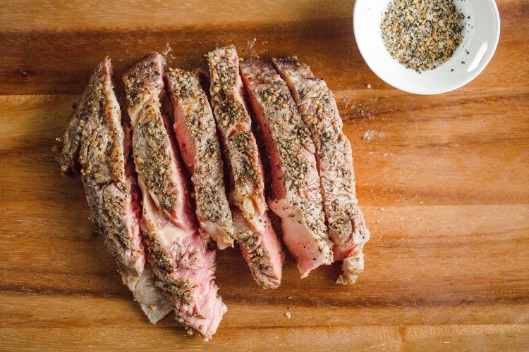 Air Fryer steak cut into slices on a cutting board