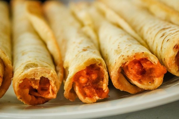 Closeup of air fryer taquitos on a plate