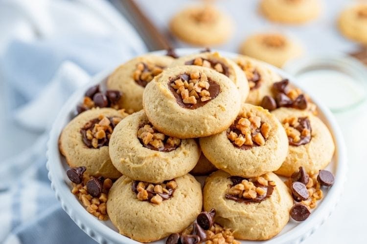 Chocolate Toffee Bit Cookies stacked on a white plate