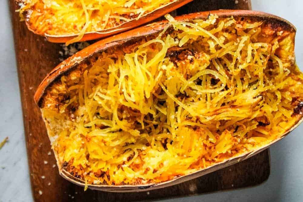 Cooked air fried spaghetti squash with parmesan still in the spaghetti squash halves