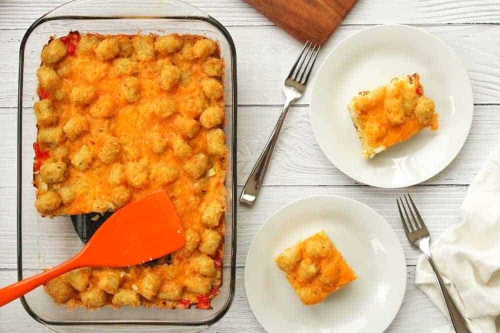 Tater Tot Casserole in 13x9 pan with slices cut out on white plates