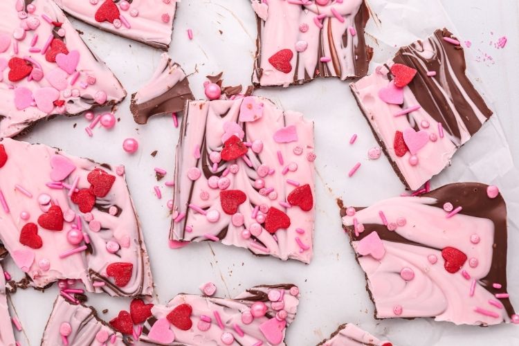 Valentine's Day Chocolate Bark broken into pieces on parchment paper