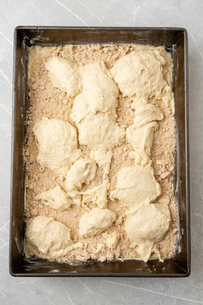 Batter topped with crumble mixture, then more dollops of batter