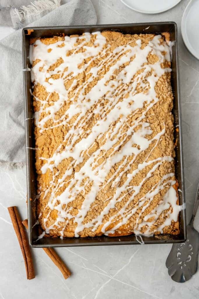 Baked coffee cake in a 13x9 pan topped with icing glaze