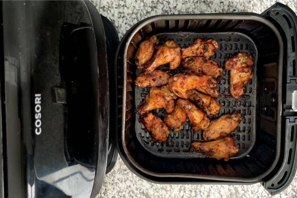 Cooked lemon pepper wings in air fryer basket