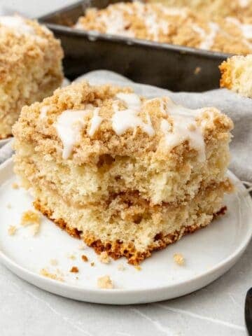 Bisquick coffee cake slice o a plate with a bite taken out of it to see the inside