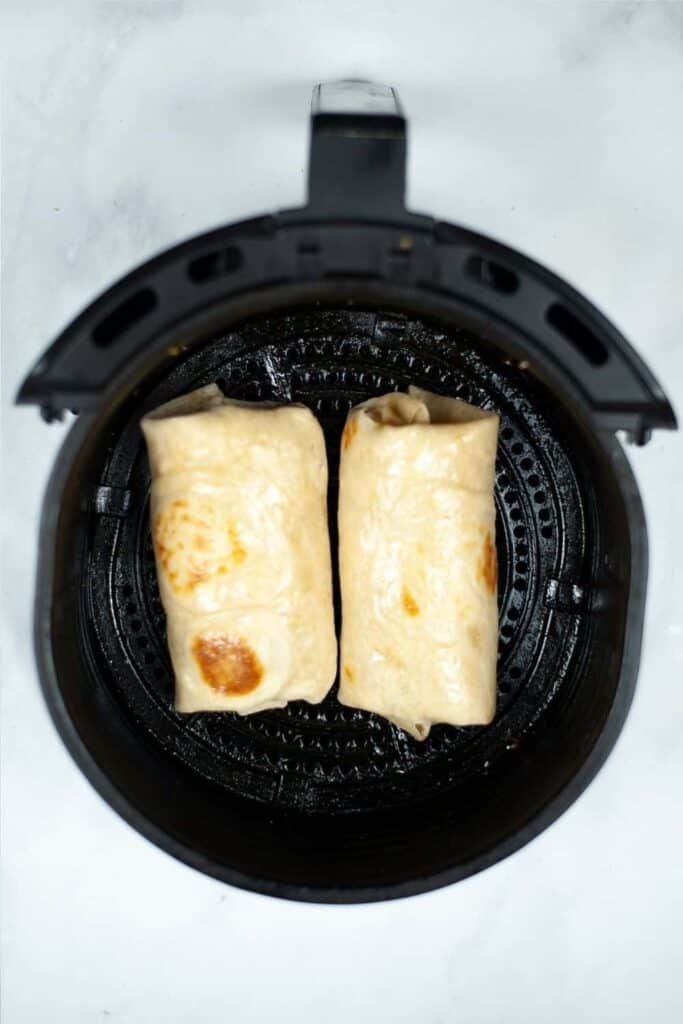 Breakfast Burrito inside the air fryer before cooking