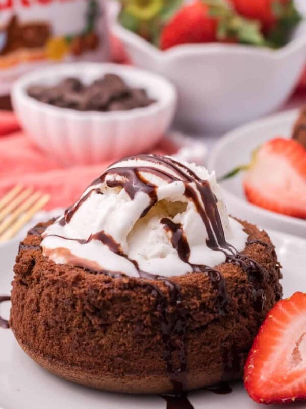 Air Fryer Lava Cake with a scoop of vanilla ice cream and chocolate syrup drizzled on top