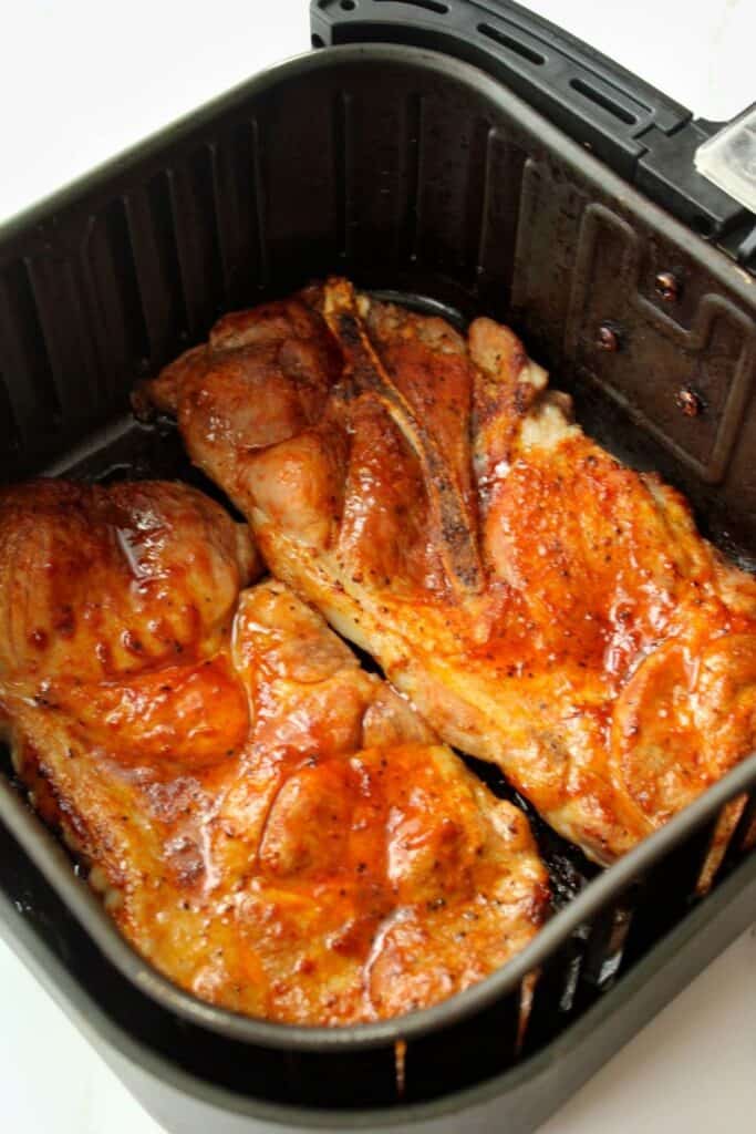 Pork Steaks in Air Fryer covered with BBQ sauce