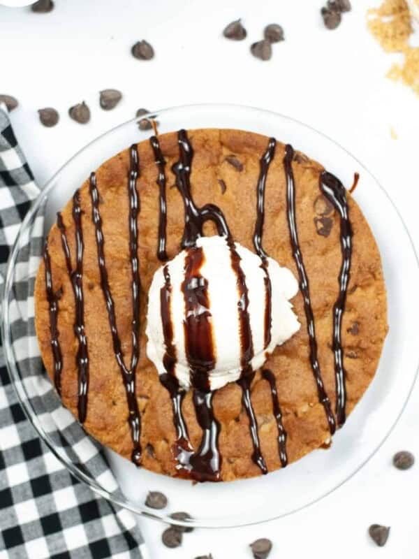 Air Fryer Cookie Cake for One from overhead with ice cream anf syrup drizzled on top